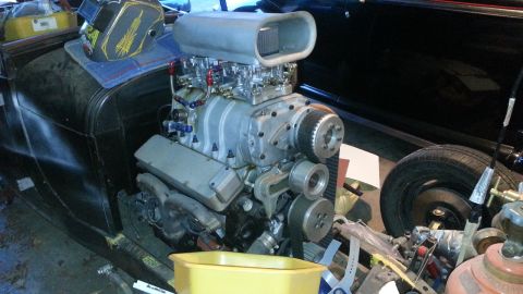 2005 Ford Mustang - Close-up of a supercharged engine, likely for a custom build, with a welding mask nearby.