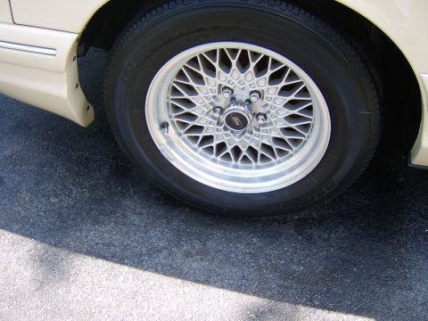 1996 Mercury Grand Marquis - Close-up of a 1996 Mercury Grand Marquis wheel and part of the fender.