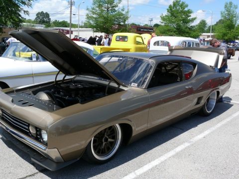 1968 Chevrolet Camaro - Custom 1969 Ford Torino GT at a car show, showing off its engine and custom modifications.