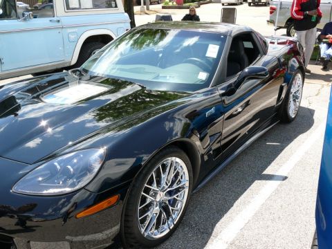 1968 Chevrolet Camaro - A black Chevrolet Corvette is parked outdoors, with a blue Ford Bronco visible to its left.