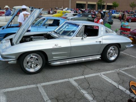 1968 Chevrolet Camaro - A classic silver Chevrolet Corvette Sting Ray is displayed at an outdoor event with its hood open.