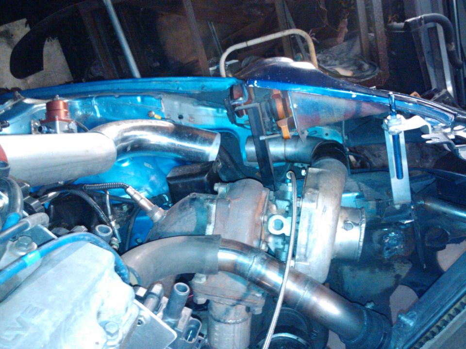 Engine bay with turbocharger, intercooler piping, and blow-off valve