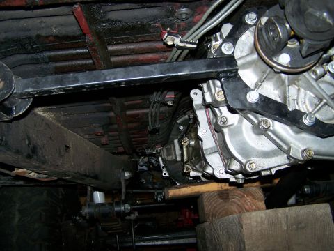 1988 Suzuki Samurai - Close-up of the drivetrain components and undercarriage of a vehicle.