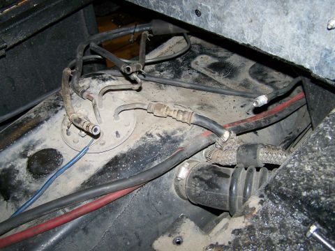 1988 Suzuki Samurai - Close-up view of a vehicle's fuel pump assembly, showing hoses and electrical connections.