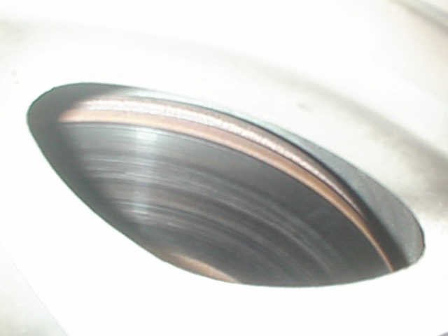 Close-up of a worn brake rotor with visible scoring