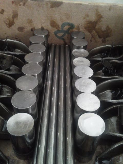 1979 Ford F-150 - Engine components, likely valve lifters and pushrods, are neatly arranged in a workshop setting.