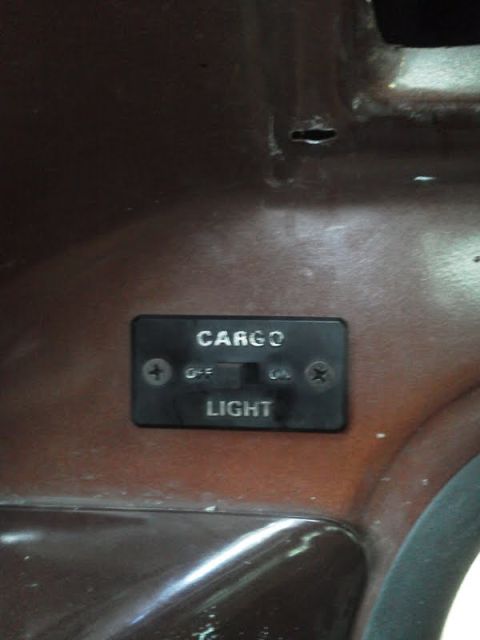 1979 Ford F-150 - Close-up of a cargo light switch on a vehicle's interior dashboard.