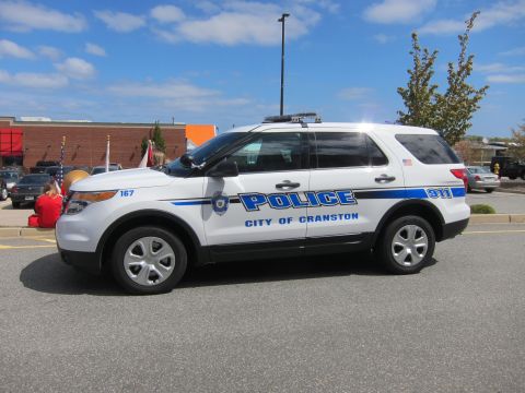 1991 Ford LTD Crown Victoria - white City of Cranston Police Ford Explorer SUV with blue striping and '911' markings parked in a lot under a blue sky.