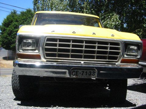 1979 Ford Bronco - This yellow Ford truck features a prominent grille and bumper, with a license plate visible on the front.