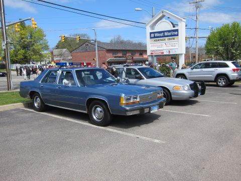 1991 Ford LTD Crown Victoria - blue Ford LTD Crown Victoria police sedan parked beside other cruisers outside a West Marine store on Aquidneck.