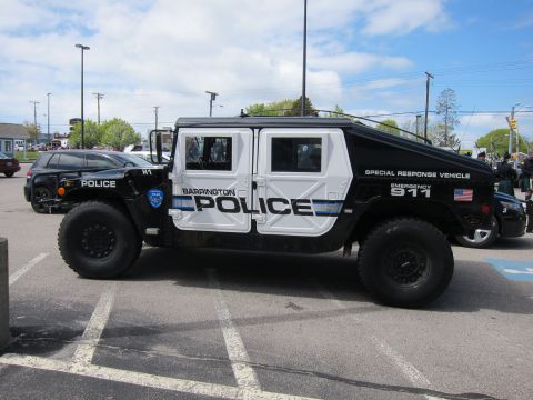 1991 Ford LTD Crown Victoria - black-and-white Barrington Police Hummer H1 Special Response Vehicle parked in striped spaces under a partly cloudy sky.