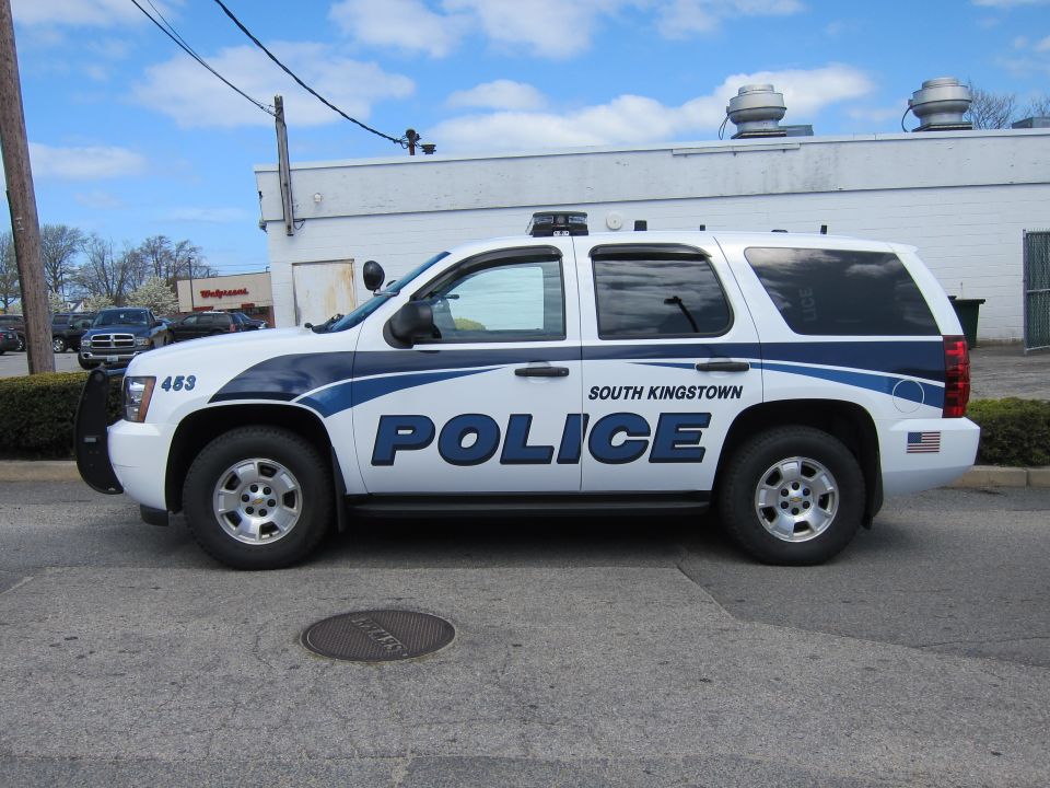 White and blue Chevrolet Tahoe South Kingstown Police SUV, side profile