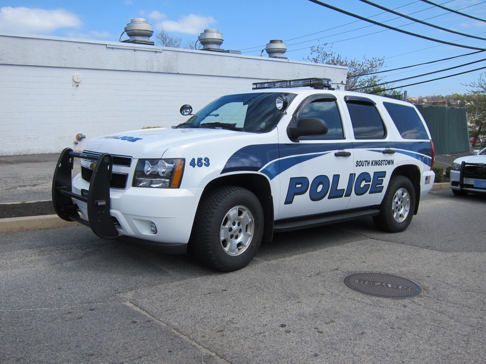 White and blue Chevrolet Tahoe South Kingstown Police SUV with push bar, front three-quarter