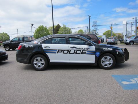 1991 Ford LTD Crown Victoria - black and white Ford Taurus marked Barrington Police, unit 3, parked in profile in a parking lot.