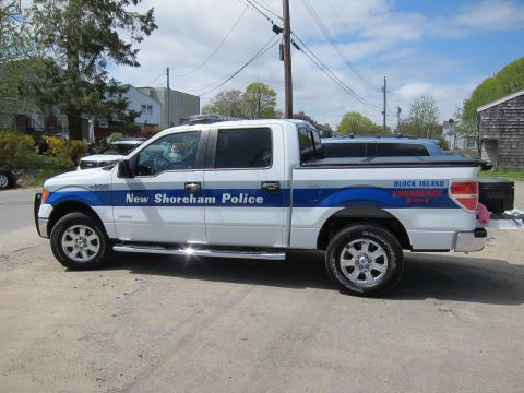 1991 Ford LTD Crown Victoria - white and blue Ford F-150 crew cab marked New Shoreham Police and Block Island Emergency 911, shown in profile.