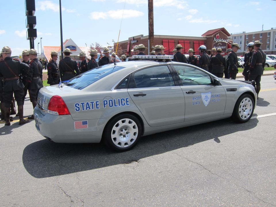 Silver Chevrolet Caprice Rhode Island State Police sedan, rear three-quarter with troopers