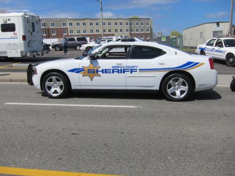 1991 Ford LTD Crown Victoria - white Dodge Charger marked Norfolk County Sheriff with front push bar, shown front-three-quarter on a street.