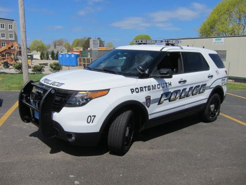 1991 Ford LTD Crown Victoria - white Ford Explorer Portsmouth Police SUV unit 07 with brush guard and roof light bar parked in a sunny lot.