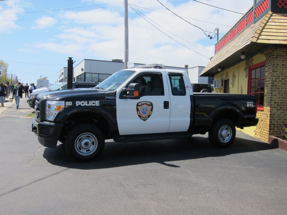 Black and white Ford F-250 Newport Police pickup truck, side view