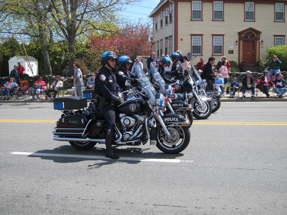 Police officers riding Harley-Davidson motorcycles in a street parade