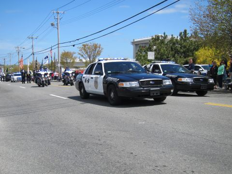 1991 Ford LTD Crown Victoria - black-and-white Springfield Police K-9 Ford Crown Victoria leads a column of cruisers and motorcycles down a street.