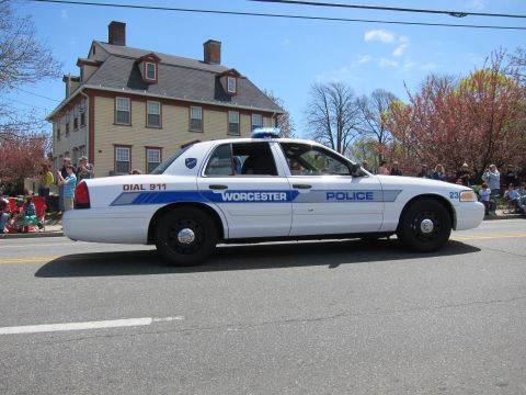 1991 Ford LTD Crown Victoria - white Worcester Police Ford Crown Victoria marked Dial 911 drives a parade route past a tan colonial home and crowd.