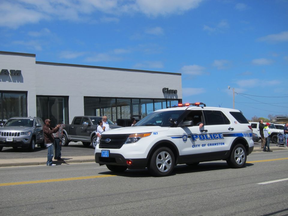 White City of Cranston Police SUV with red roof lights on a street