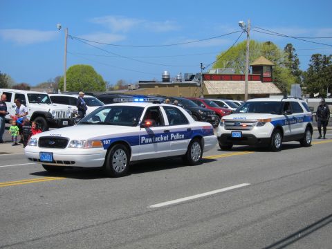 1991 Ford LTD Crown Victoria - white Pawtucket Police Crown Victoria and a Pawtucket Police Ford Explorer drive together past a pizzeria building.