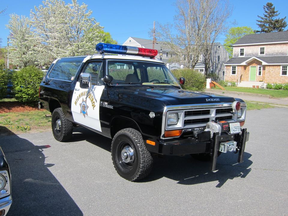 Black and white Dodge Ramcharger 4x4 with Highway Patrol markings and front winch in a driveway