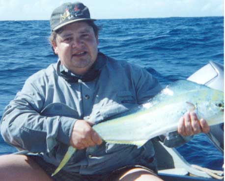 1979 Ford Bronco - A man proudly displays a freshly caught fish while out on the water.