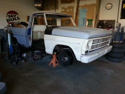 1967 Ford F-100 - This 1967 Ford F-100 is in a garage, with its front end elevated on jack stands for maintenance.