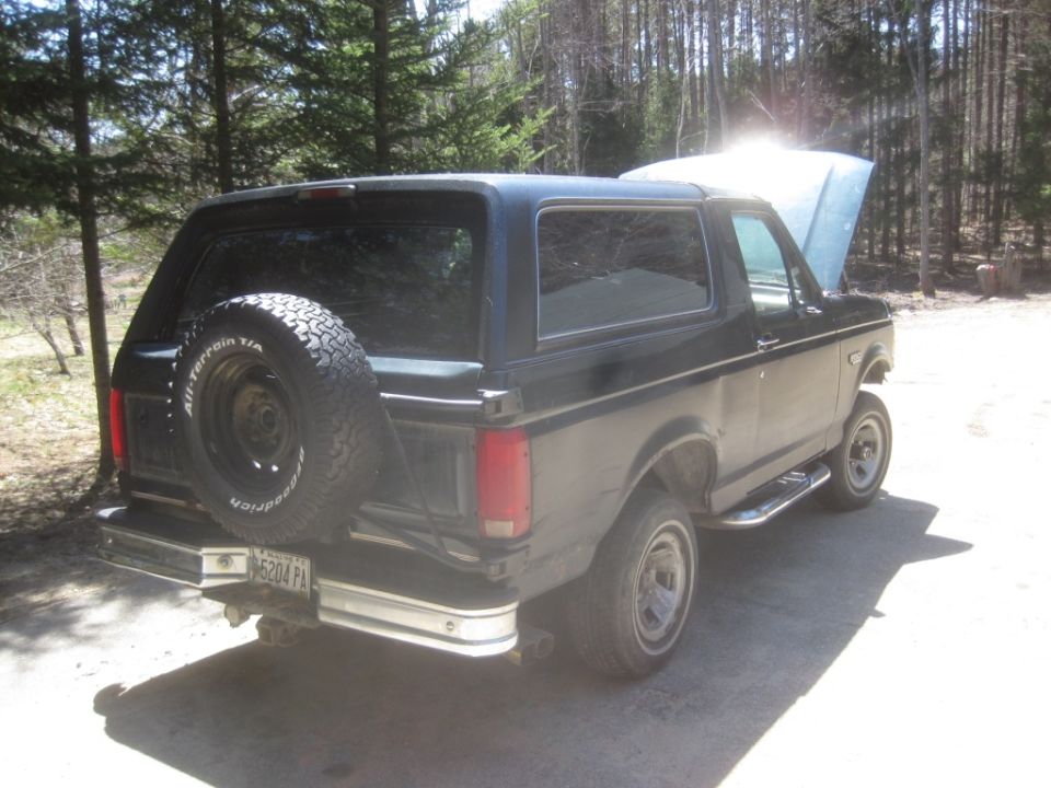 Black 1993 Ford Bronco parked outdoors with hood open