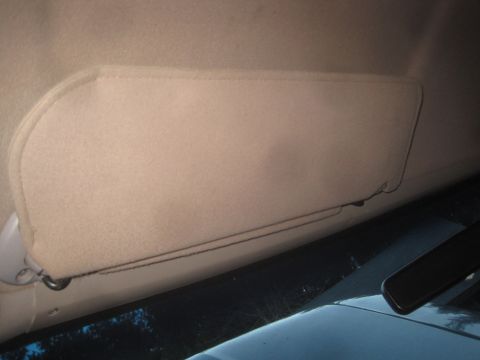 1993 Ford Bronco - Interior view of a tan sun visor, showing part of the dashboard and windshield.