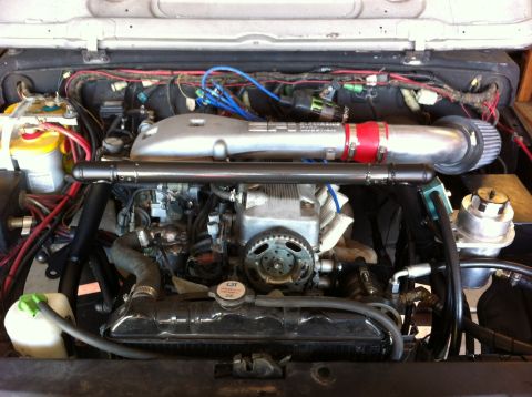 1987 Suzuki Samurai - Engine bay with aftermarket intake and exhaust manifold visible.