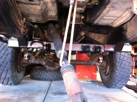 1987 Suzuki Samurai - The underside of a vehicle shows its rear axle and driveshaft assembly.