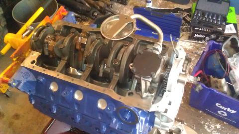 1973 Ford Torino - Engine block assembly with crankshaft and oil pump, partially disassembled and on an engine stand.