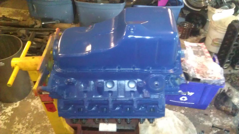Blue engine block with oil pan on stand