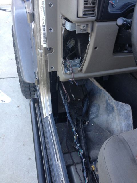 2005 Jeep Wrangler - Interior view of a Jeep Wrangler with the dashboard partially disassembled, revealing wiring and internal components.