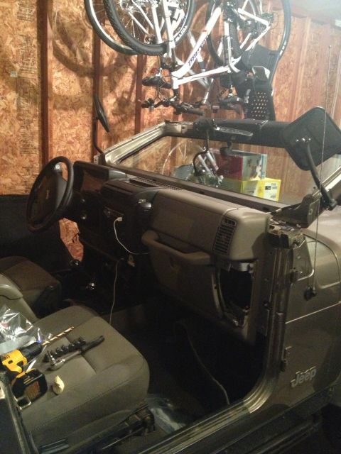 2005 Jeep Wrangler - Interior view of a Jeep Wrangler, showing the dashboard, steering wheel, and seats with tools present.