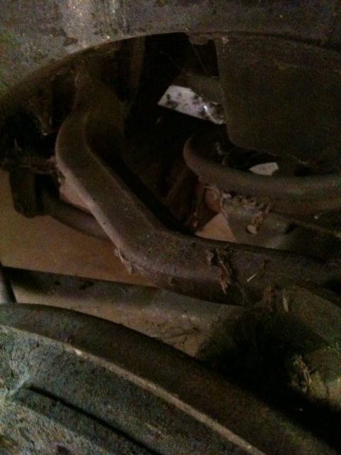 1975 Ford Ranchero - Undercarriage view showing suspension parts and frame elements, with some dust and debris.