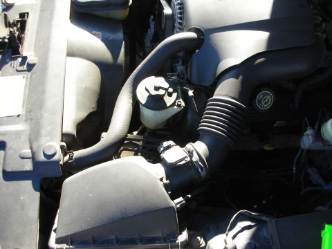 1998 Ford Crown Victoria - Close-up view of an engine bay, showing various components and hoses.