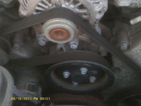 2006 Ford Crown Victoria - Close-up view of an engine's belt and pulley system, with a timestamp indicating it was photographed on September 19, 2011.