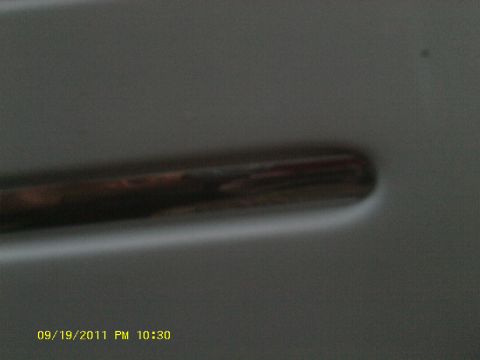 2006 Ford Crown Victoria - A close-up shot of a car's door handle, with a date and time stamp in the corner.