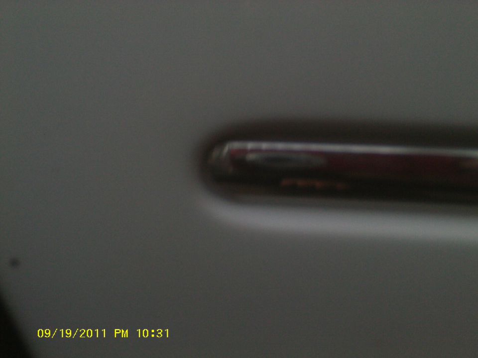 Close-up of a car door handle on a gray vehicle
