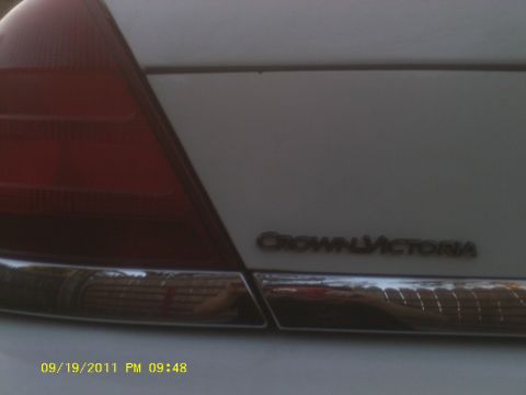 2006 Ford Crown Victoria - Close-up of the rear of a white Crown Victoria, showing the taillight and chrome trim.
