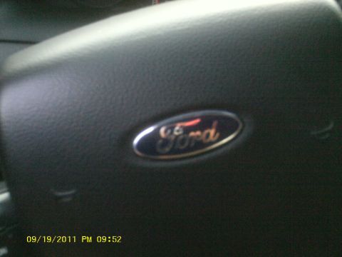 2006 Ford Crown Victoria - A Ford emblem is visible on the steering wheel of a vehicle.