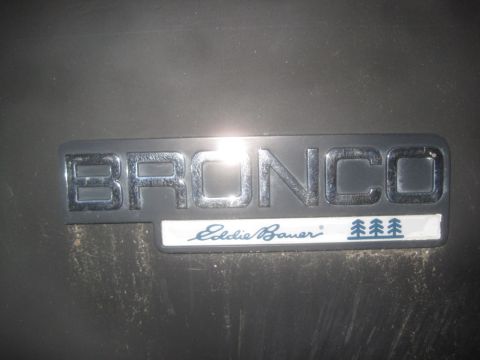 1993 Ford Bronco - Close-up of a Ford Bronco Eddie Bauer emblem, likely from the 1990s.