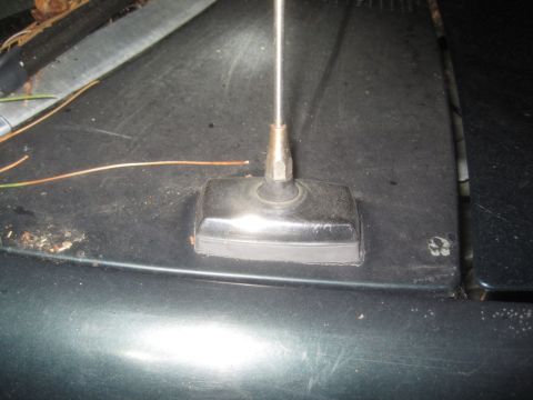 1993 Ford Bronco - Close-up of an antenna base on a dark vehicle hood, with a Supermotors.net watermark visible in the lower right corner.