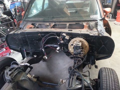 1973 Chevrolet Nova - Firewall and engine bay of a 1973 Chevrolet Nova undergoing restoration, showing brake booster and wiring.