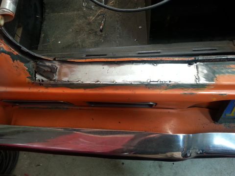1973 Chevrolet Nova - Door sill repair on a 1973 Chevrolet Nova, showing a freshly welded metal patch.